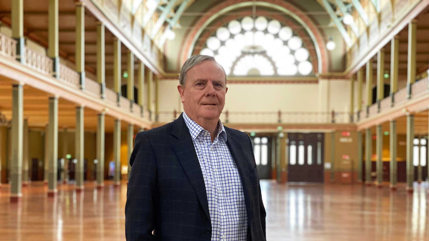 Peter Costello, former Australian Treasurer, standing in a grand hall